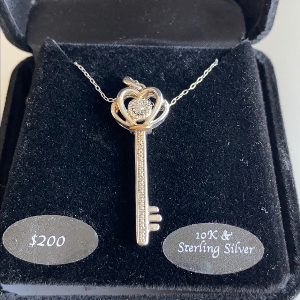 Genuine Diamond/ sterling silver key pendant.